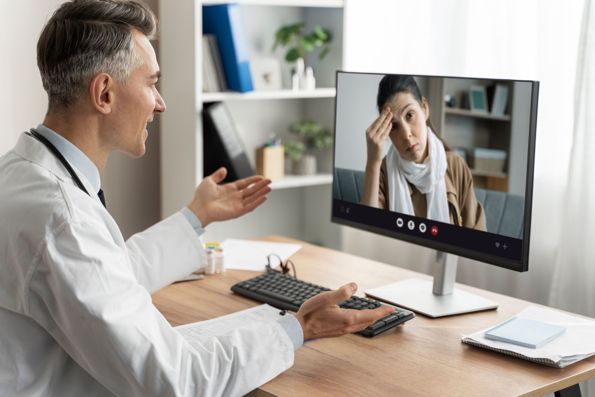 A doctor is talking to a patient on a video call.