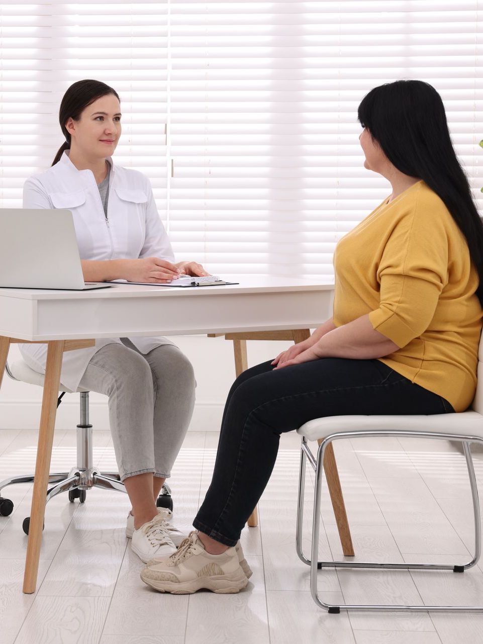 A woman is getting an injection in her arm.
