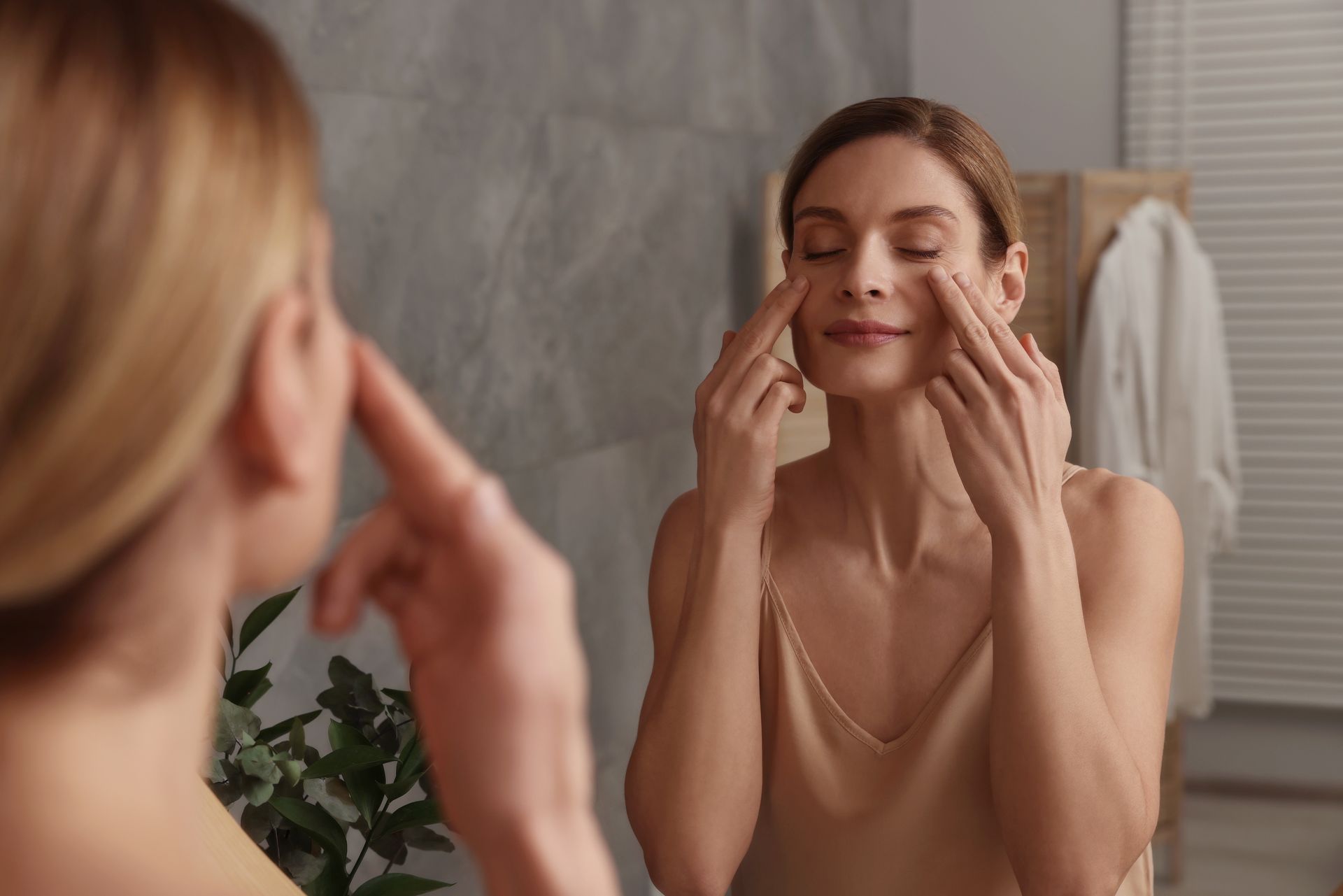 a woman touching her cheeks