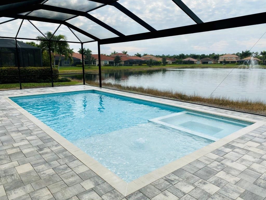 A large swimming pool with a view of a lake