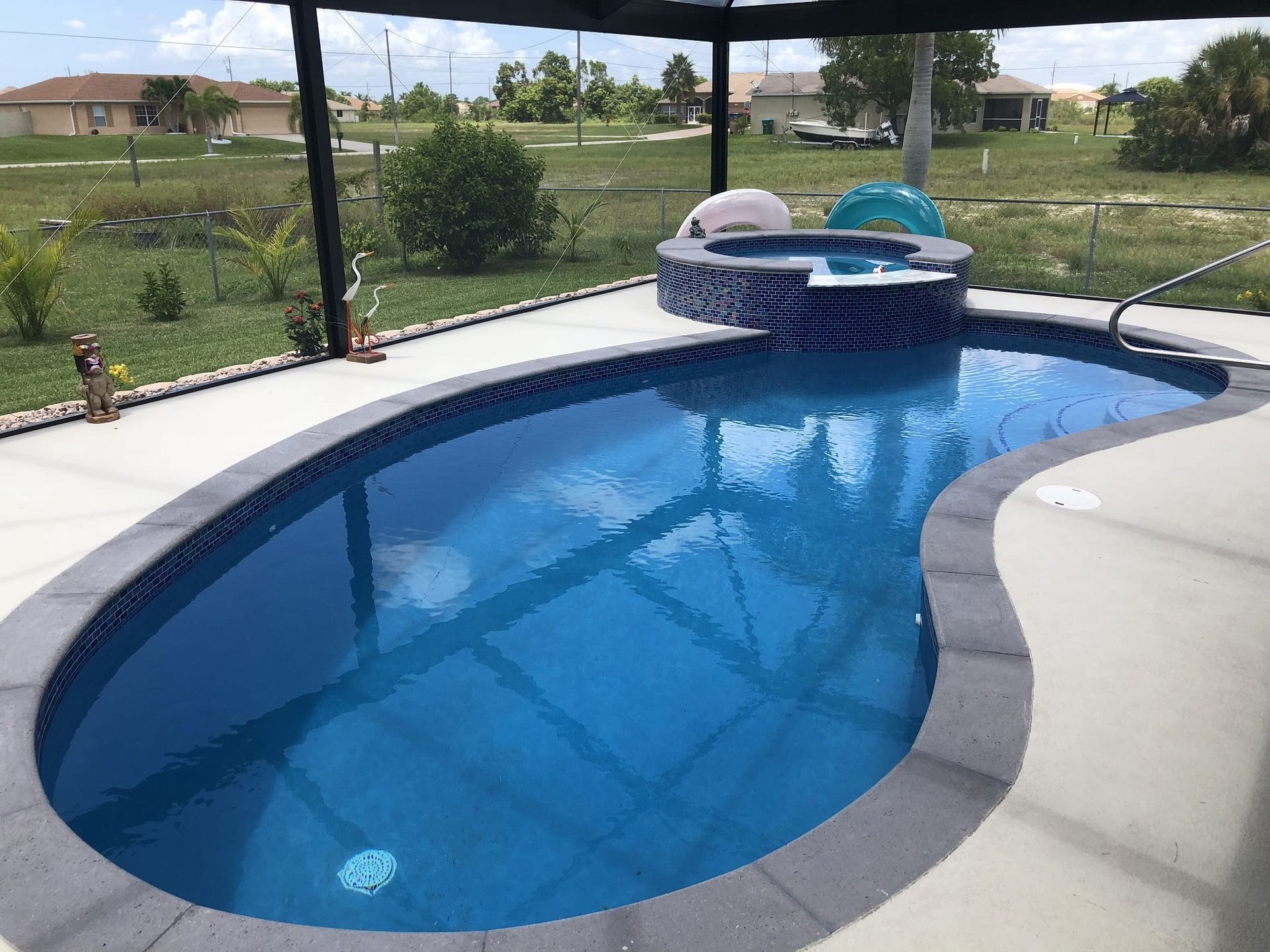 A large swimming pool with a hot tub in the middle