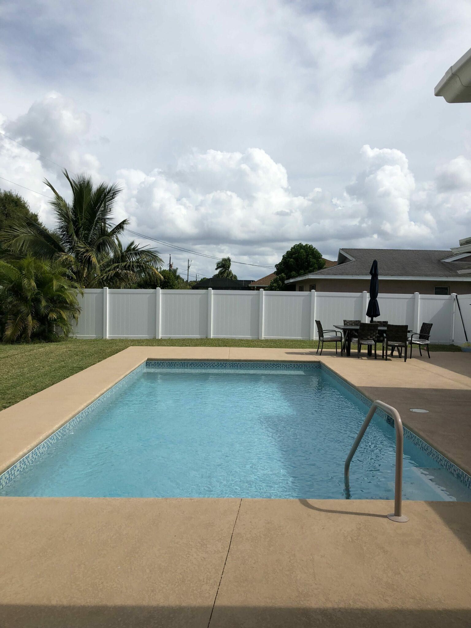 A large swimming pool in the backyard of a house