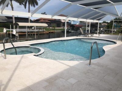 A large swimming pool with a hot tub in the middle