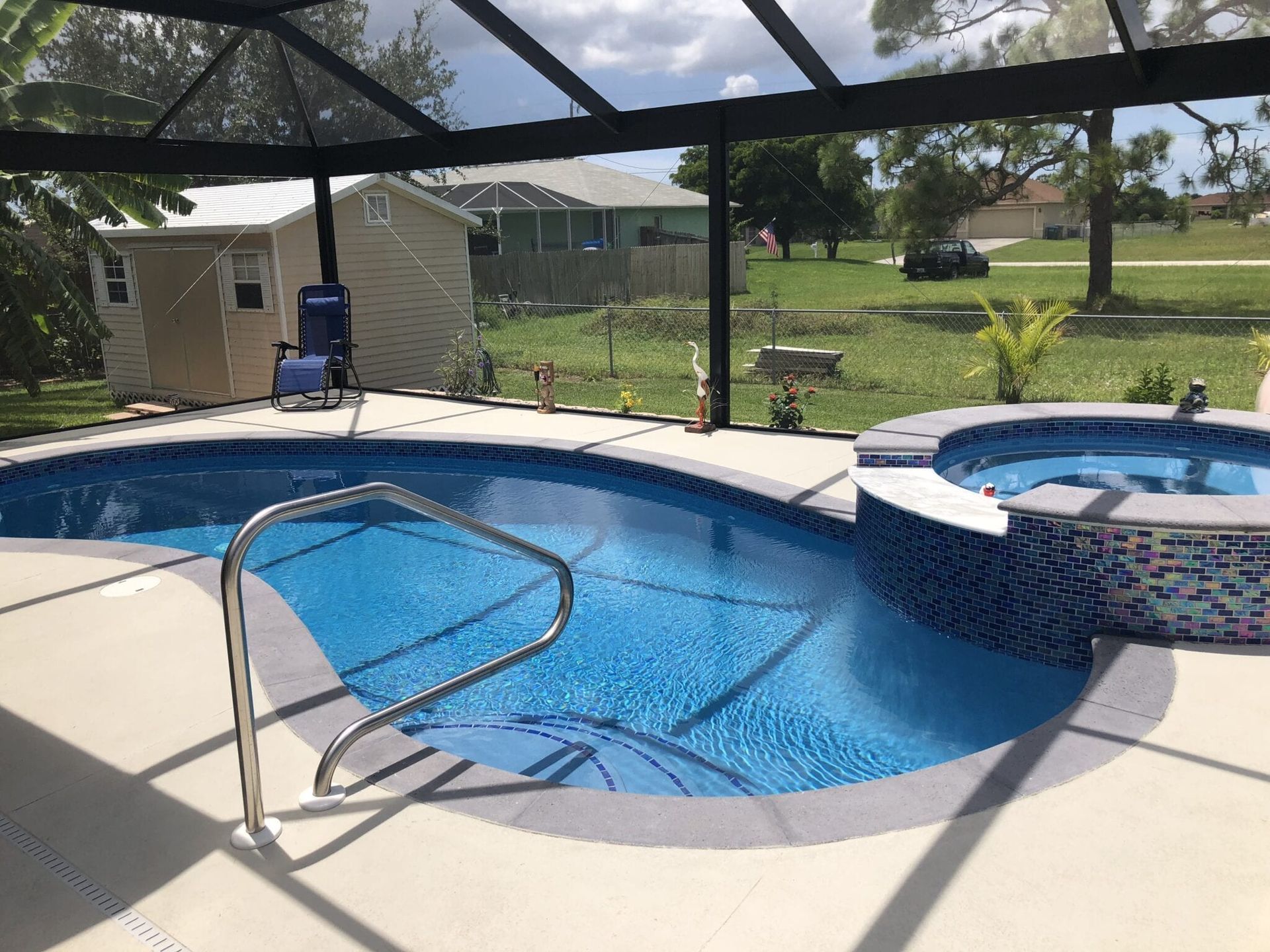 There is a swimming pool and a hot tub in the backyard.