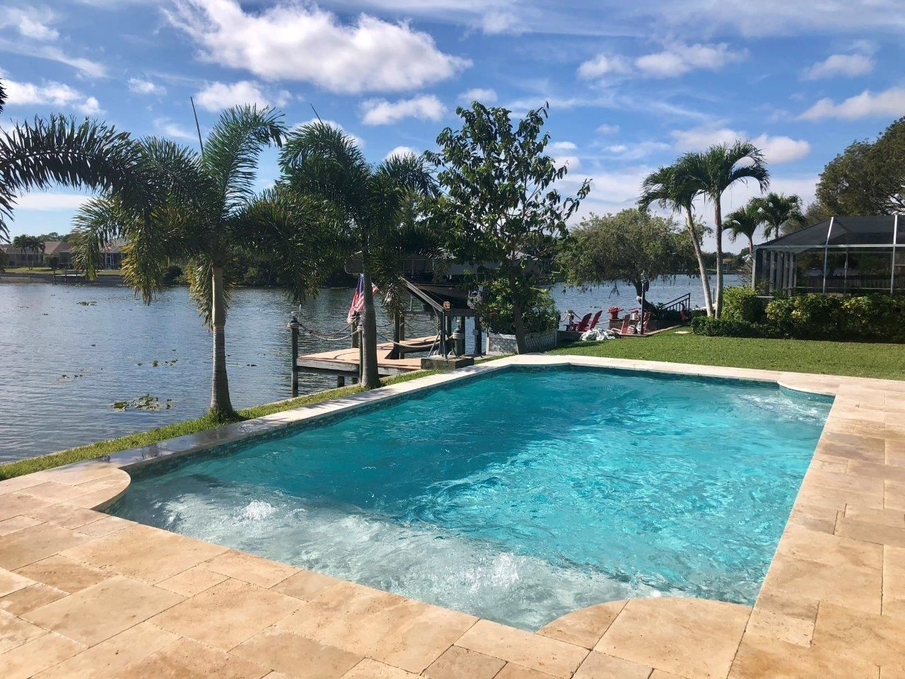 A large swimming pool with a view of a lake