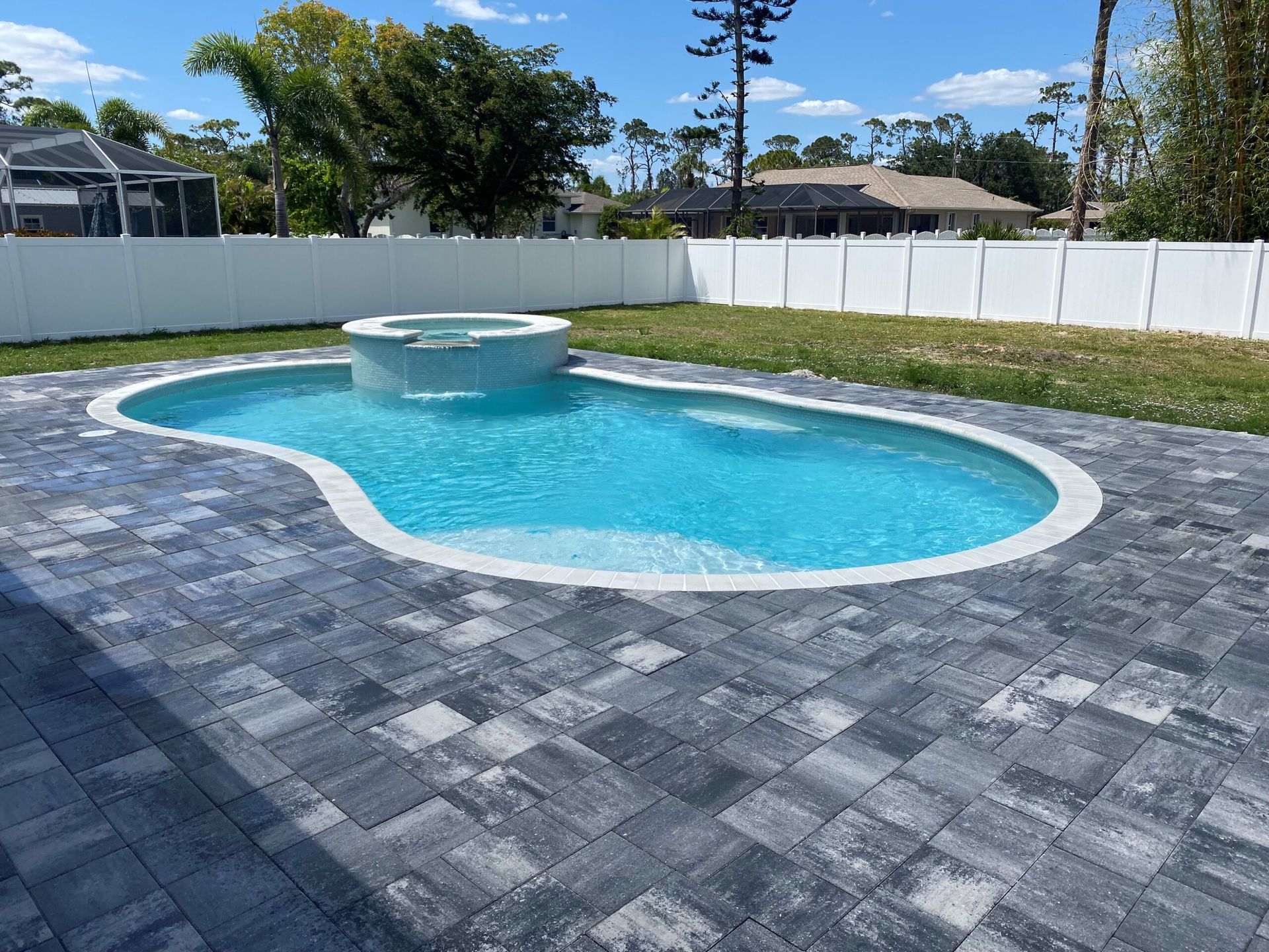 A large swimming pool in the backyard of a house built by Into h2o Pools & Spas Cape Coral