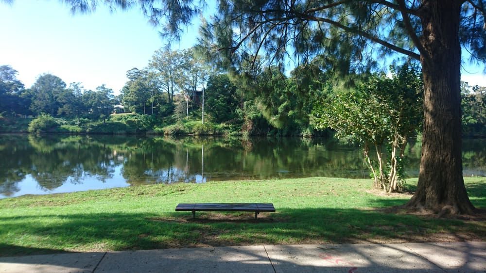 Bench on Grassy Bank Overlooking a Lake, Trees in Background — Frosty Solutions Air Conditioning In Rylstone, NSW