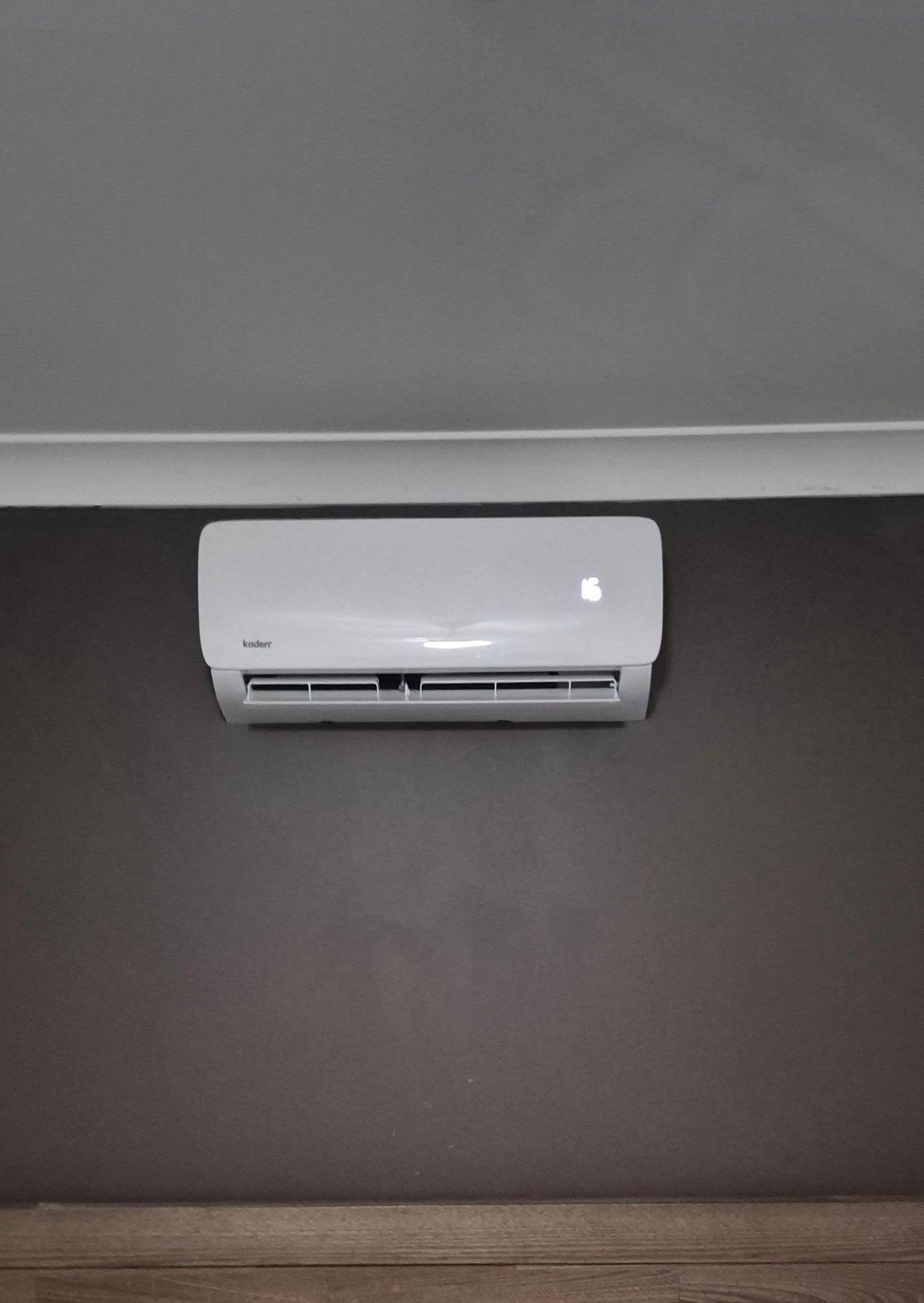 Air Conditioner Over a Bed With Green Pillows — Frosty Solutions Air Conditioning In Dunedoo, NSW