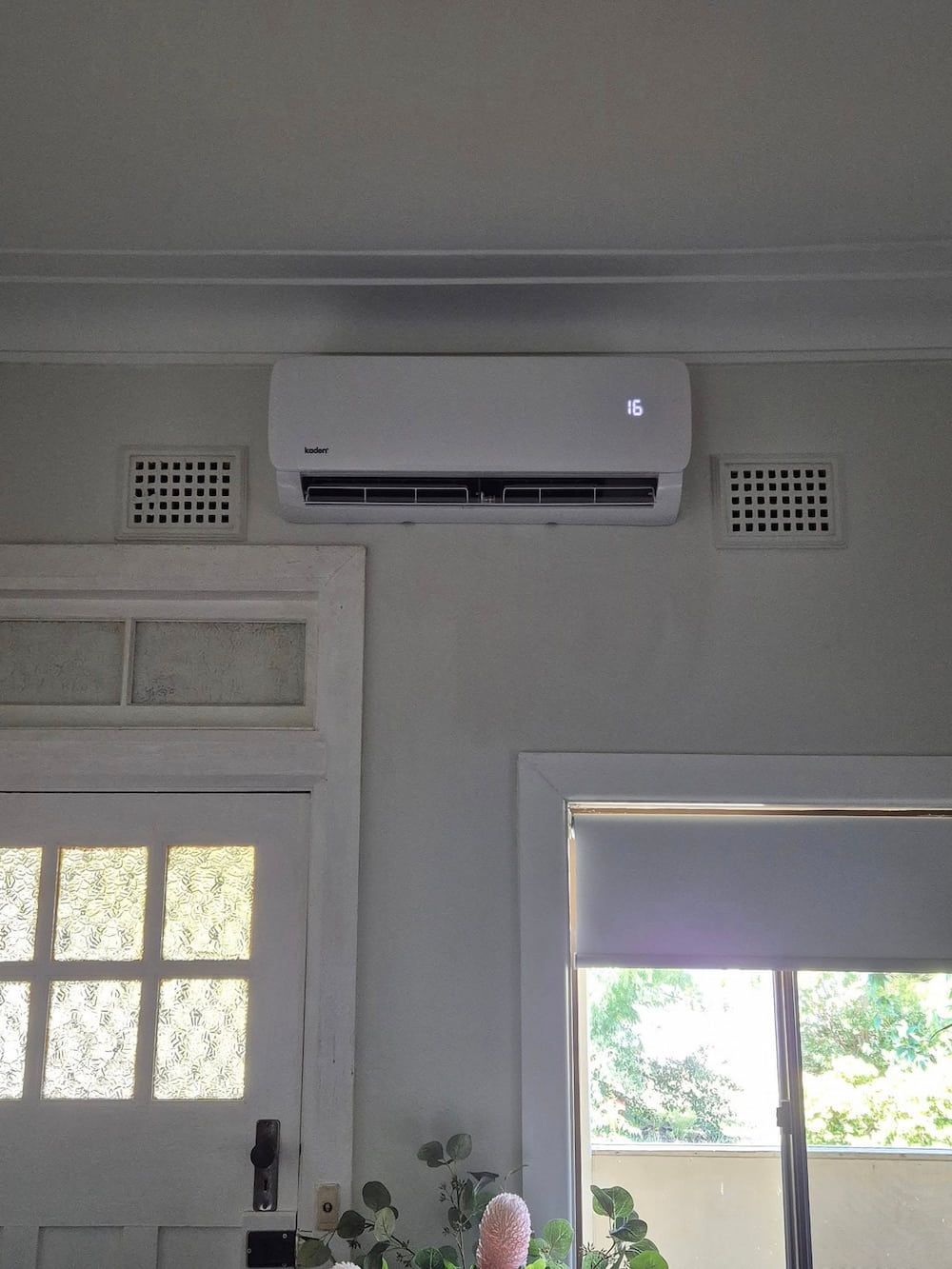 White Air Conditioner Mounted on a Light Gray Wall — Frosty Solutions Air Conditioning In Mudgee, NSW
