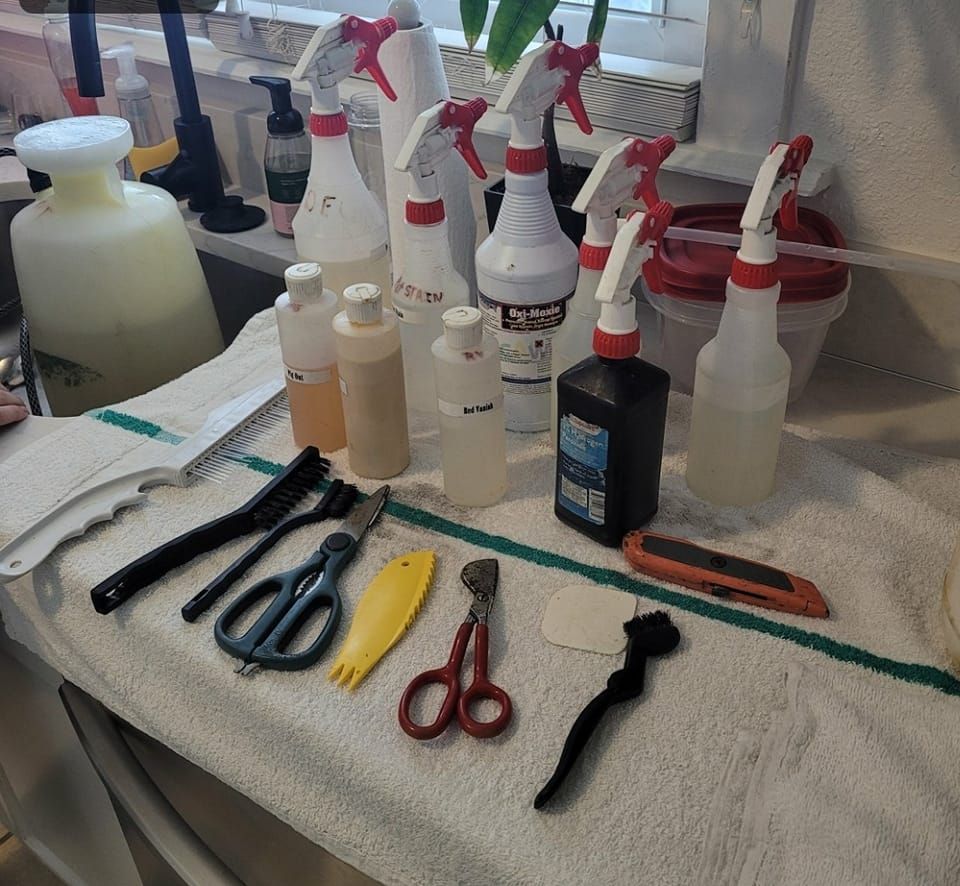 A bunch of spray bottles and scissors on a towel