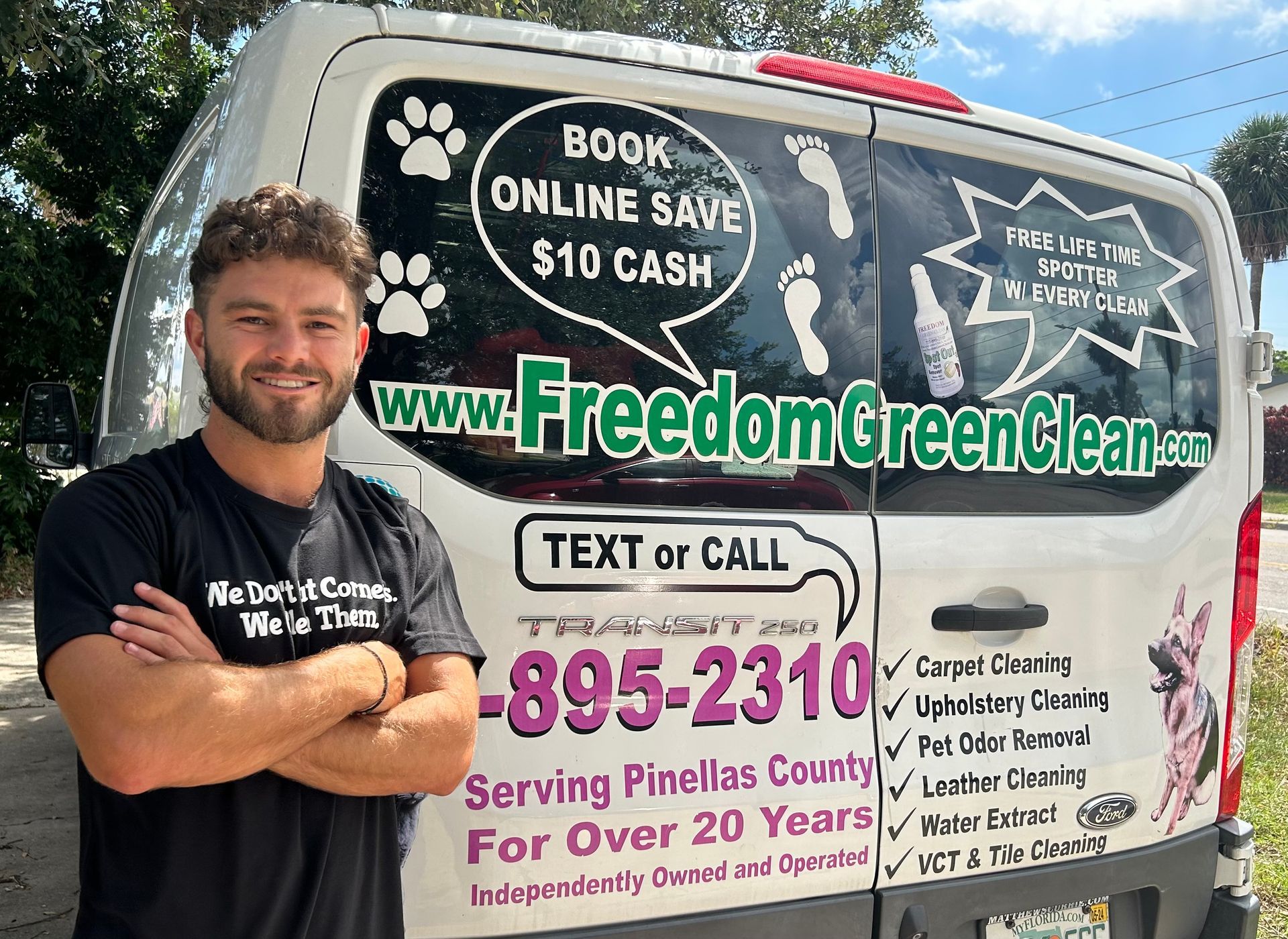 A man is standing in front of a freedom green cleaner van.