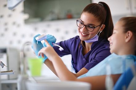 Dental Cleaning — Dentist Educates Little Girl in Hillsborough, NJ