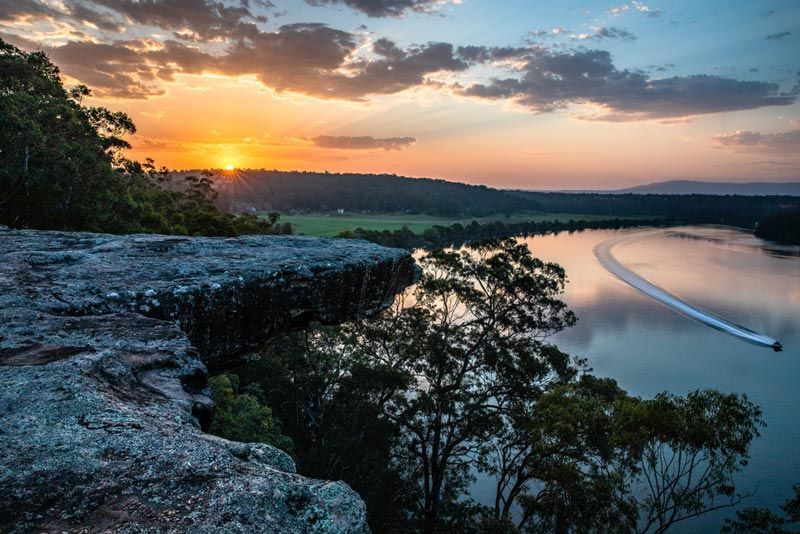 On a Cliff During Sunset With A River On Right Side — Bridge Plumbing & Trades in Shoalhaven, NSW