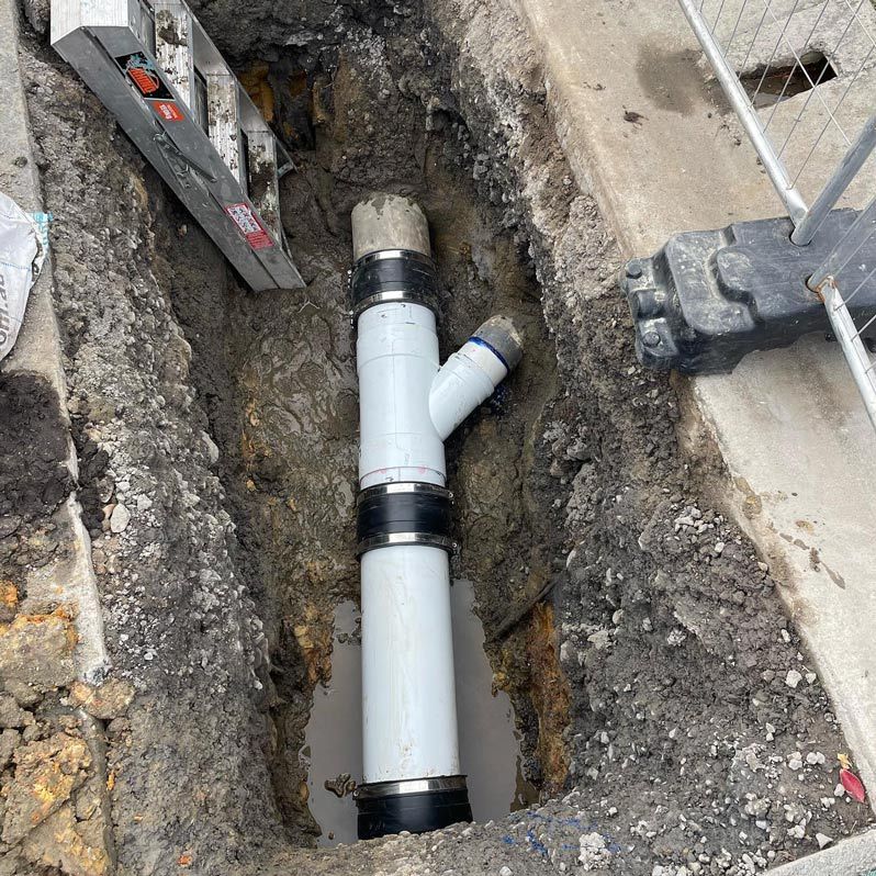 Newly Connected White Pipe With A Branching Pipe — Bridge Plumbing & Trades in Nowra, NSW