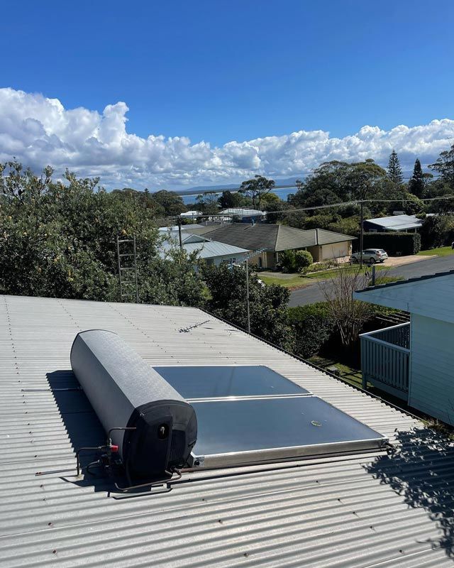 Water Solar Panel On The Roof Of A House — Bridge Plumbing & Trades in Nowra, NSW