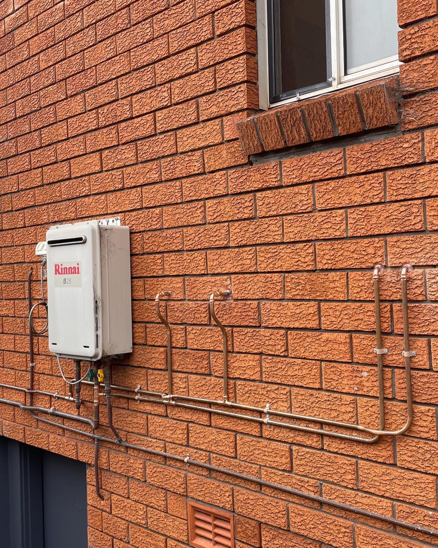 Gas Hot Water Cylinder Attached To A Wall — Bridge Plumbing & Trades in Nowra, NSW