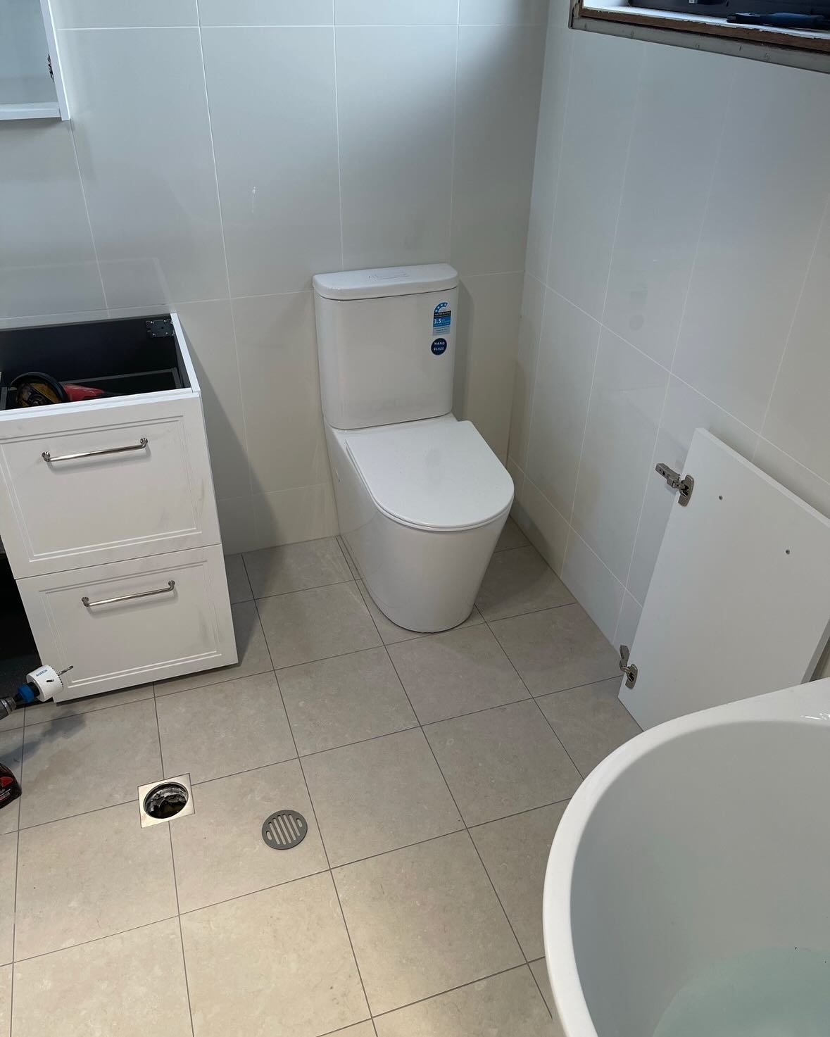A Bathroom With a Toilet, Sink, and Bathtub — Bridge Plumbing & Trades in Nowra, NSW