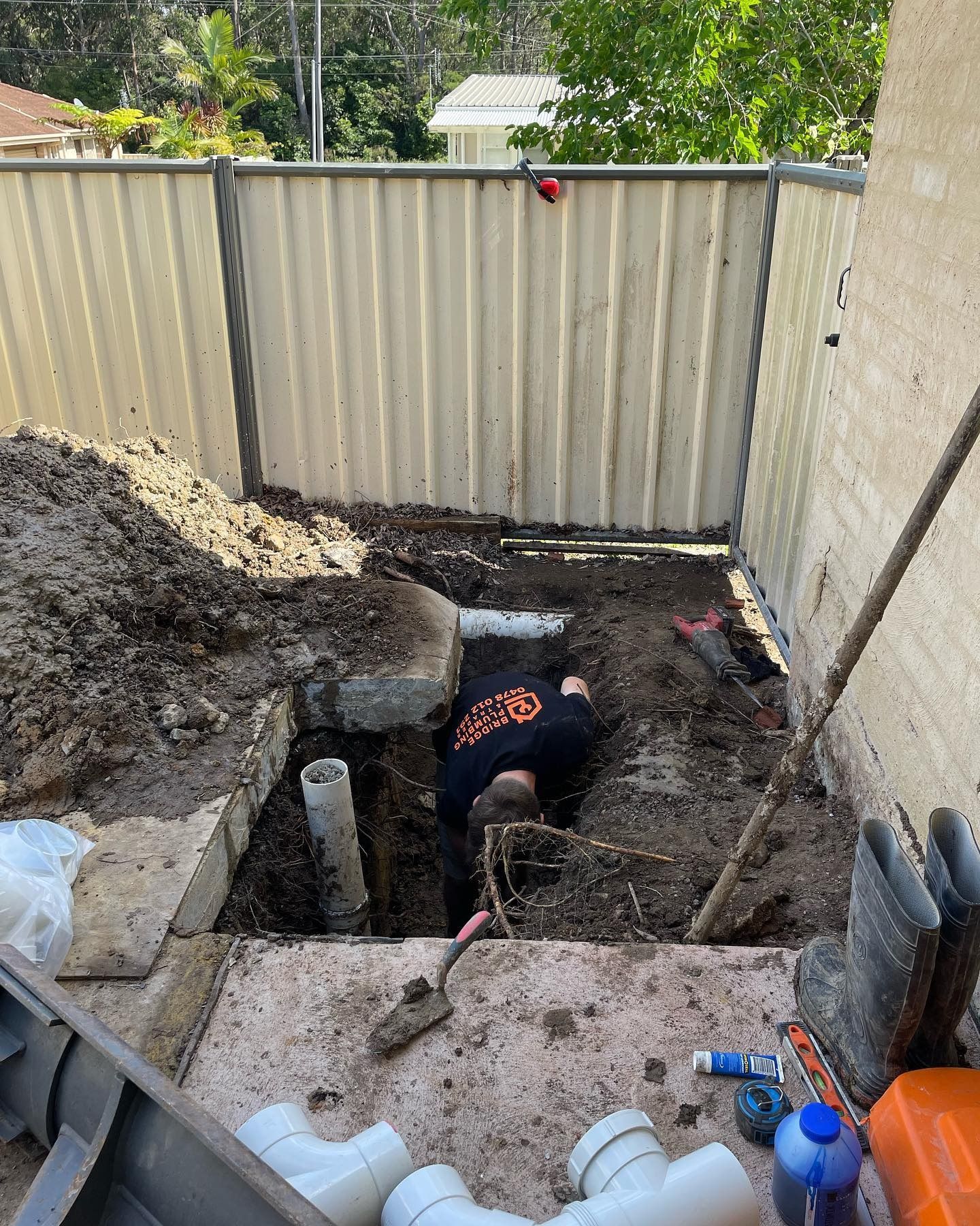 Plumber Working on Pipes Under Ground