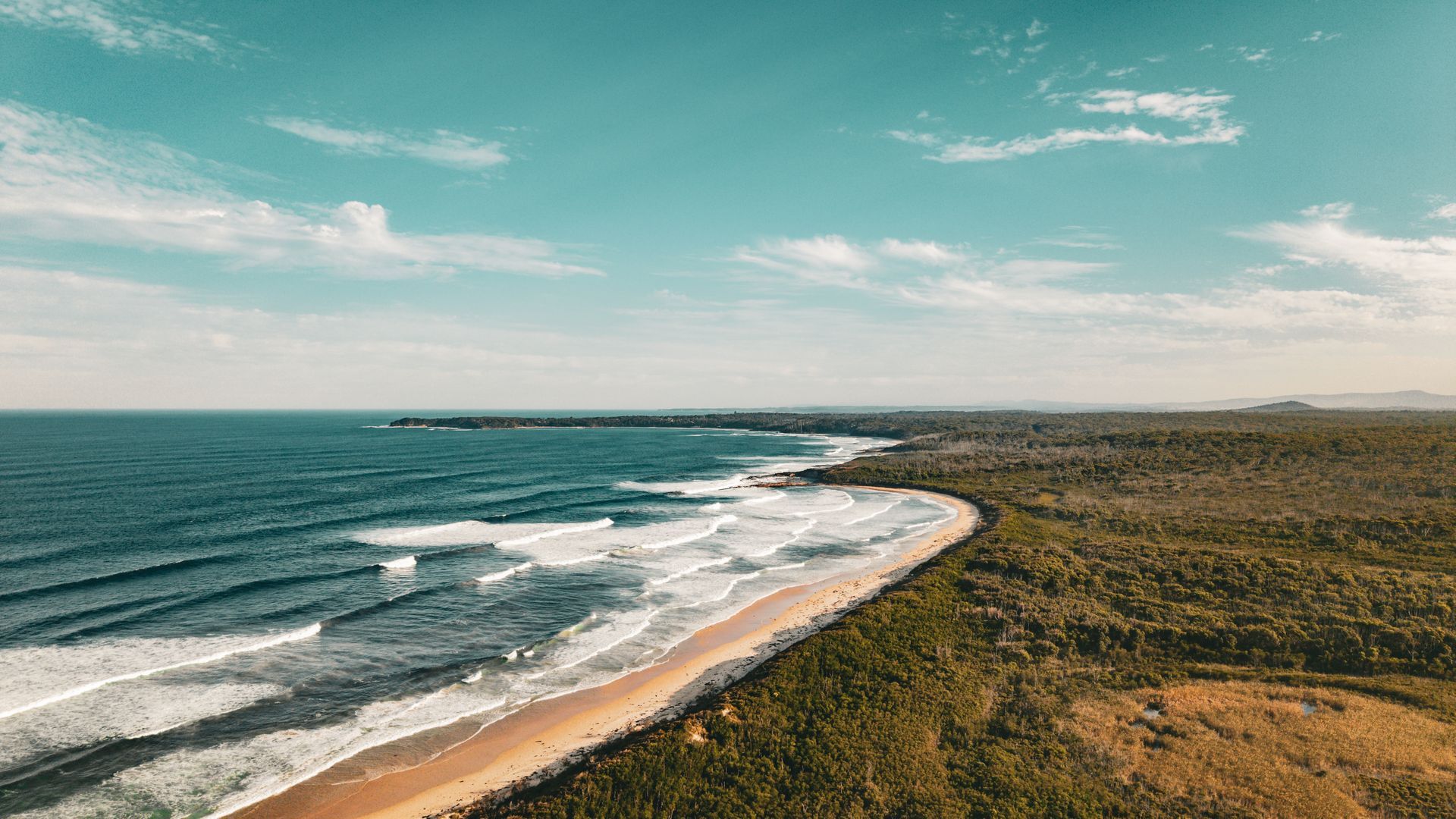 A Beach With Waves and Sandy Shore — Bridge Plumbing & Trades In Jervis Bay, NSW