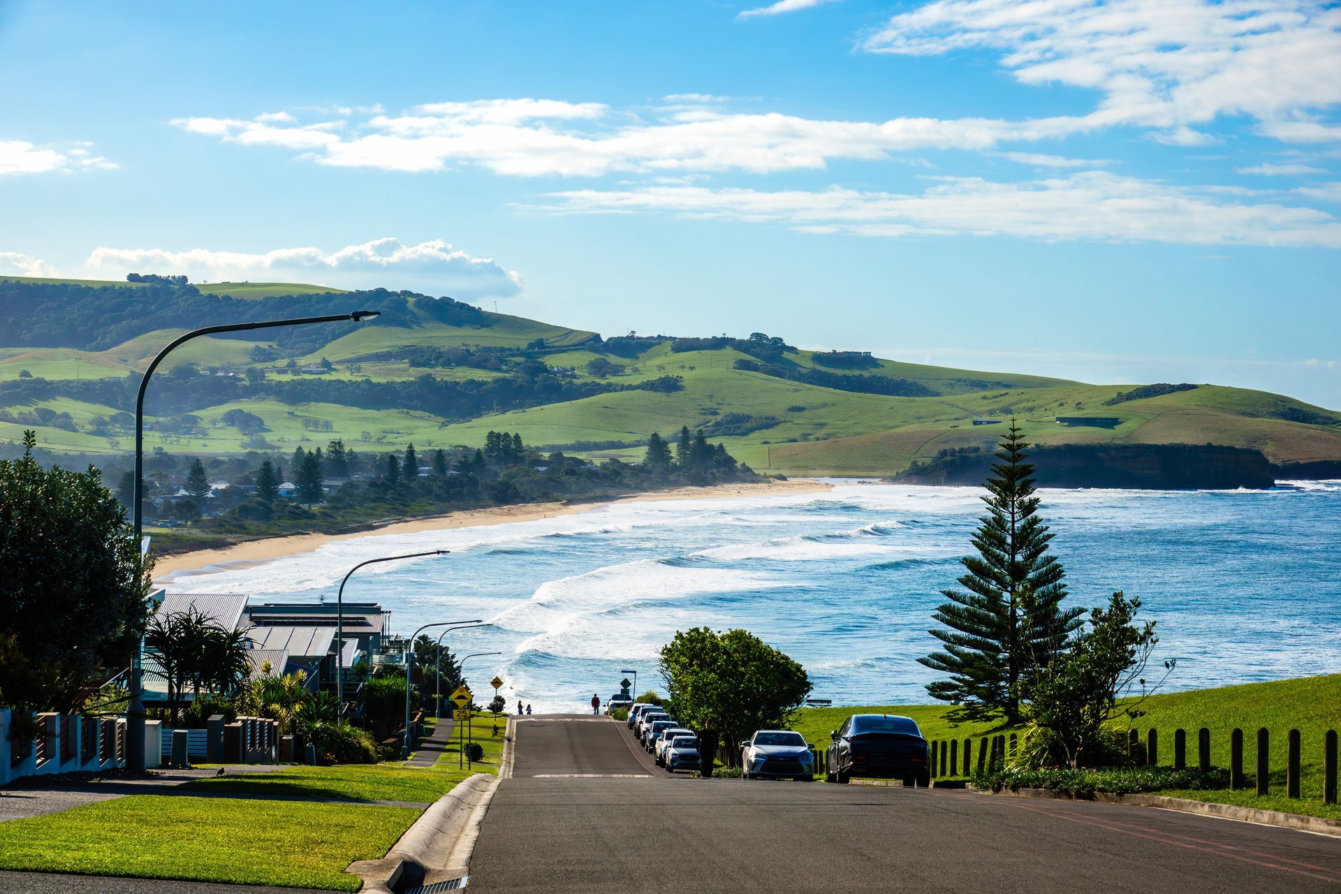 Road Slopes Toward a Beach With Ocean Waves — Bridge Plumbing & Trades In Gerringong, NSW