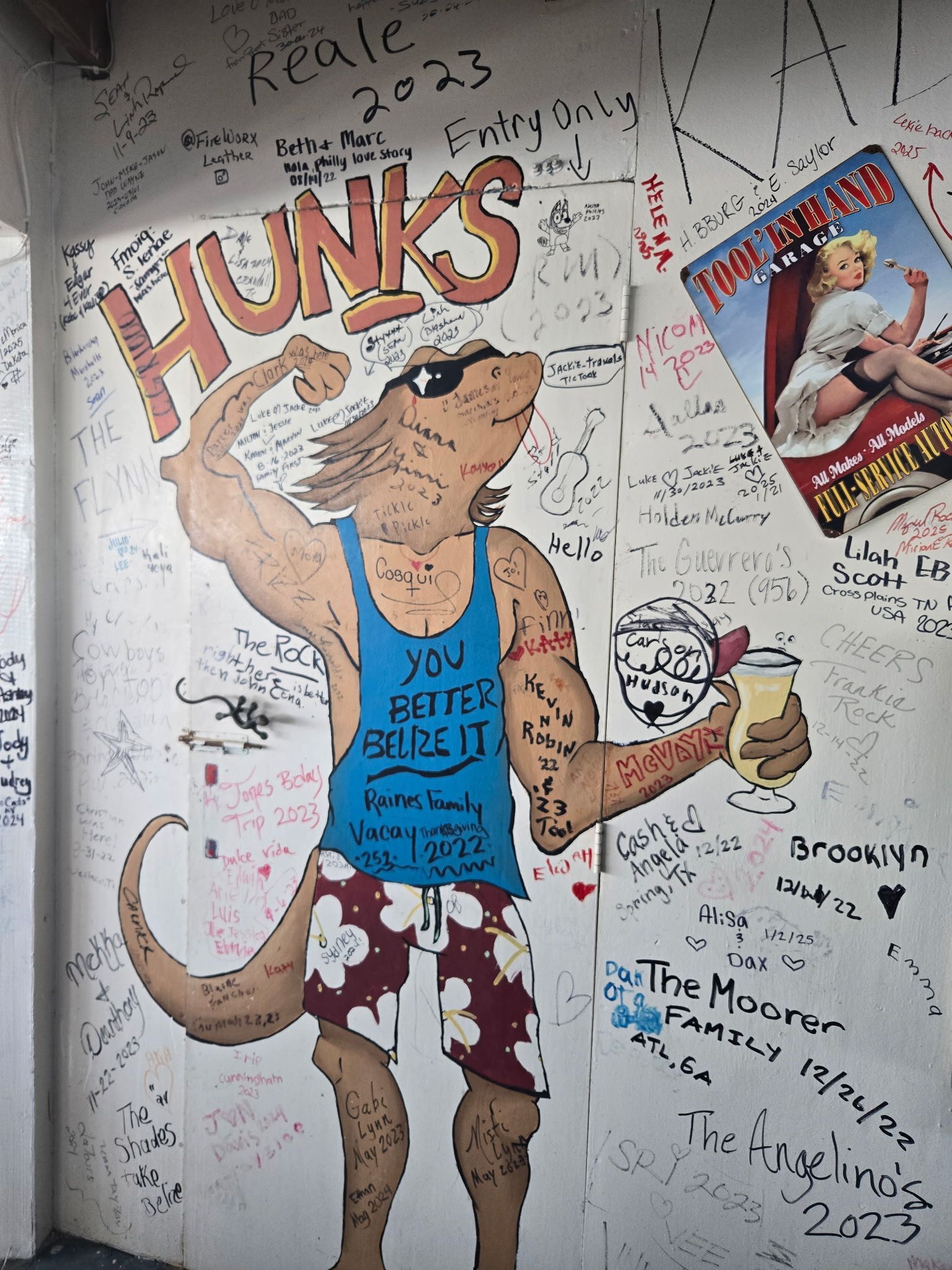 Cartoon kangaroo flexing, wearing sunglasses, tank top, and shorts. 