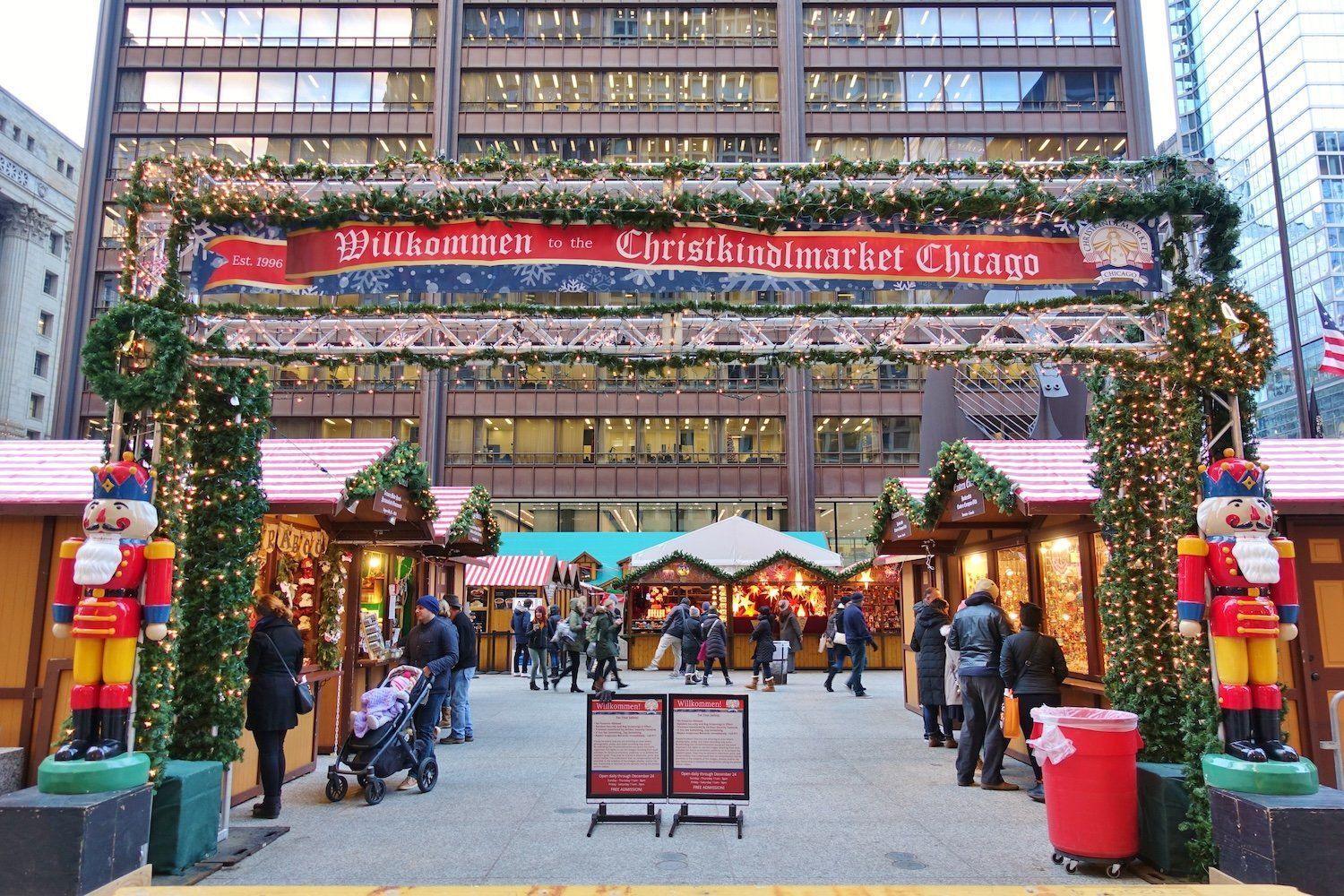 A nutcracker is standing in front of a christmas market in chicago