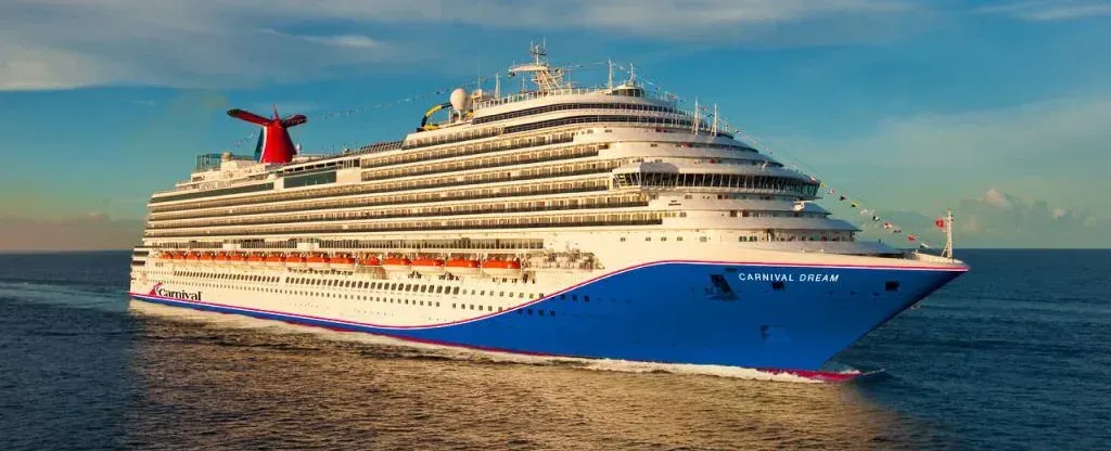 A large cruise ship is floating on top of a body of water.