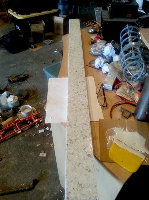 A long, light-colored, speckled stone countertop.