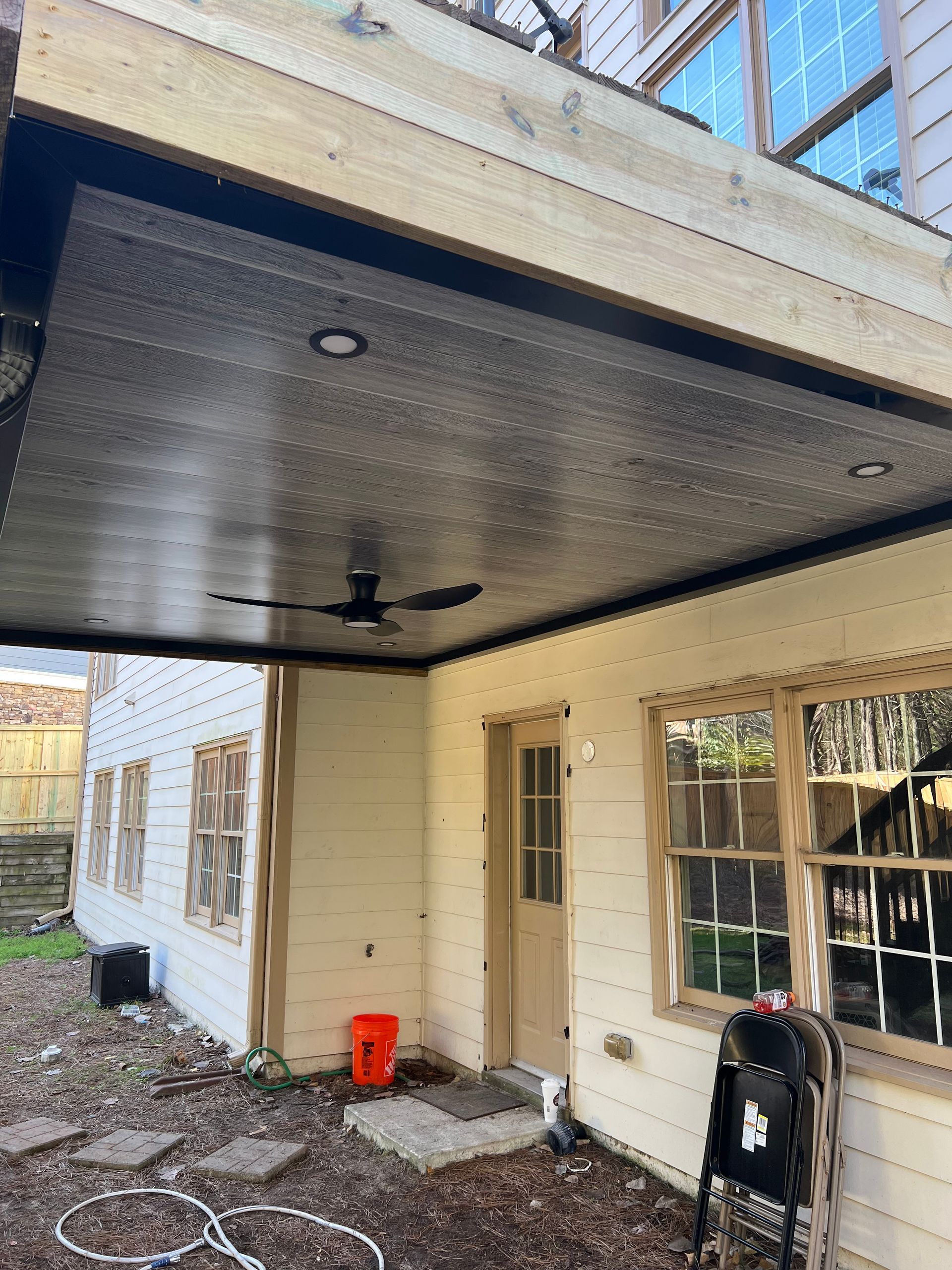Outdoor covered patio with a ceiling fan, recessed lights, and a view of the deck above.