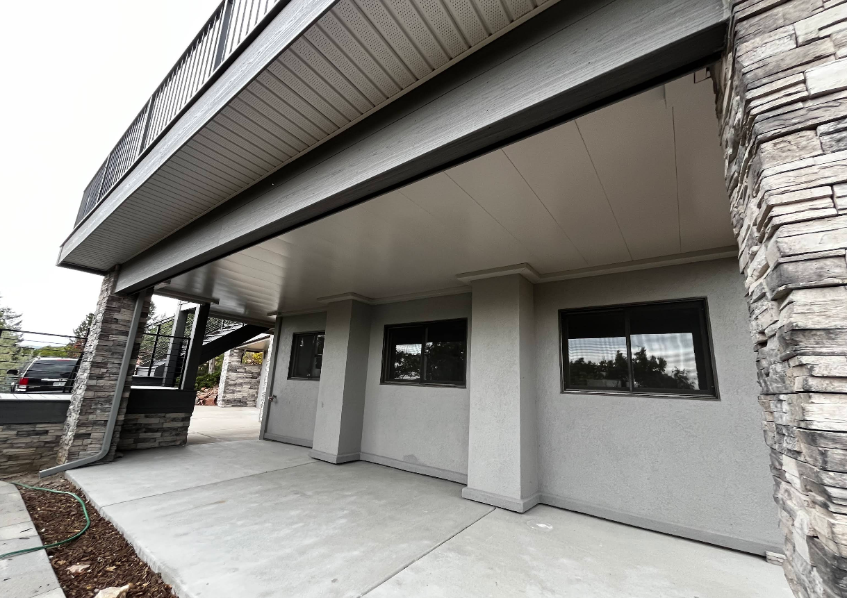Exterior of a building with stone columns and a covered walkway.