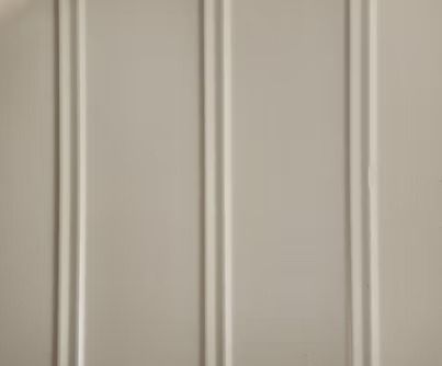 Off-white, vertical paneling with thin, raised lines.