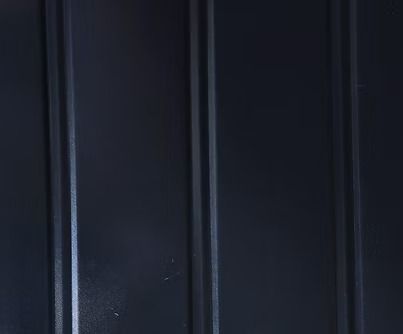 Dark blue corrugated metal panel.