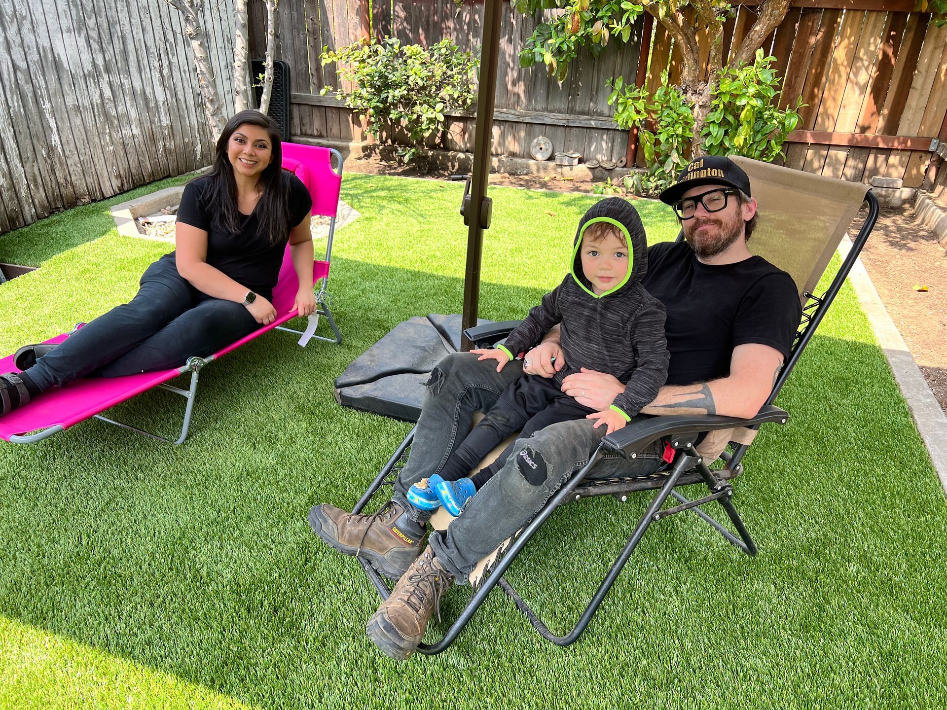 Family on lawn chairs on new turf