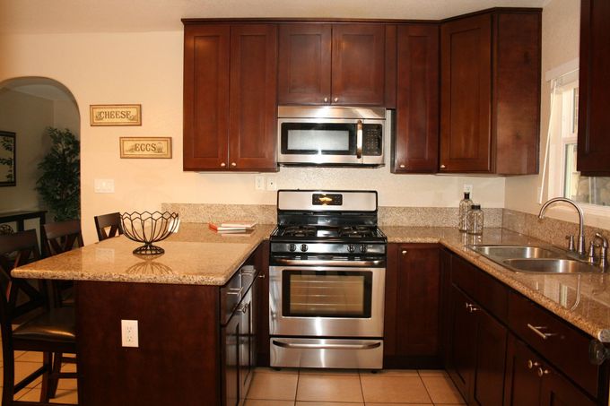A kitchen with stainless steel appliances and granite counter tops
