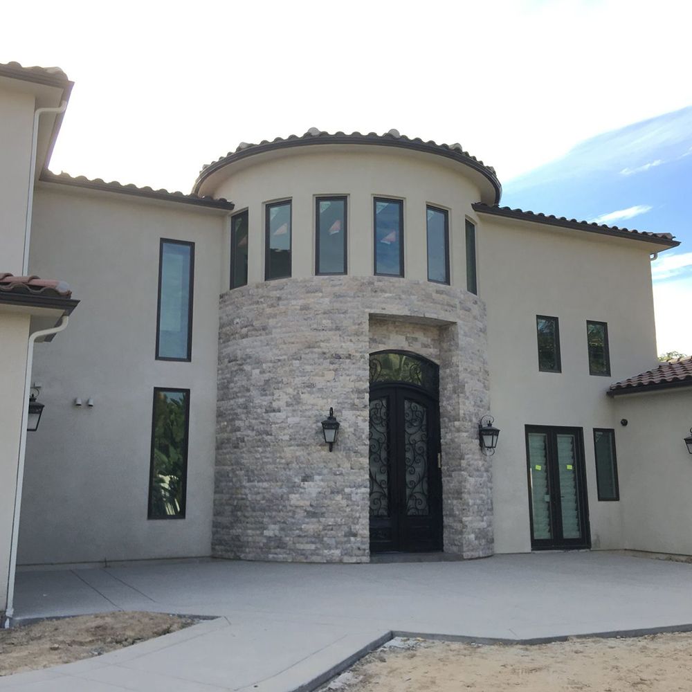 A large white house with a stone facade