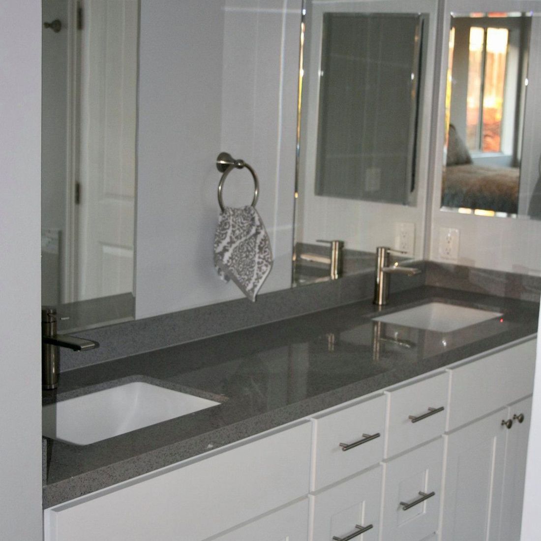 A bathroom with two sinks and a mirror