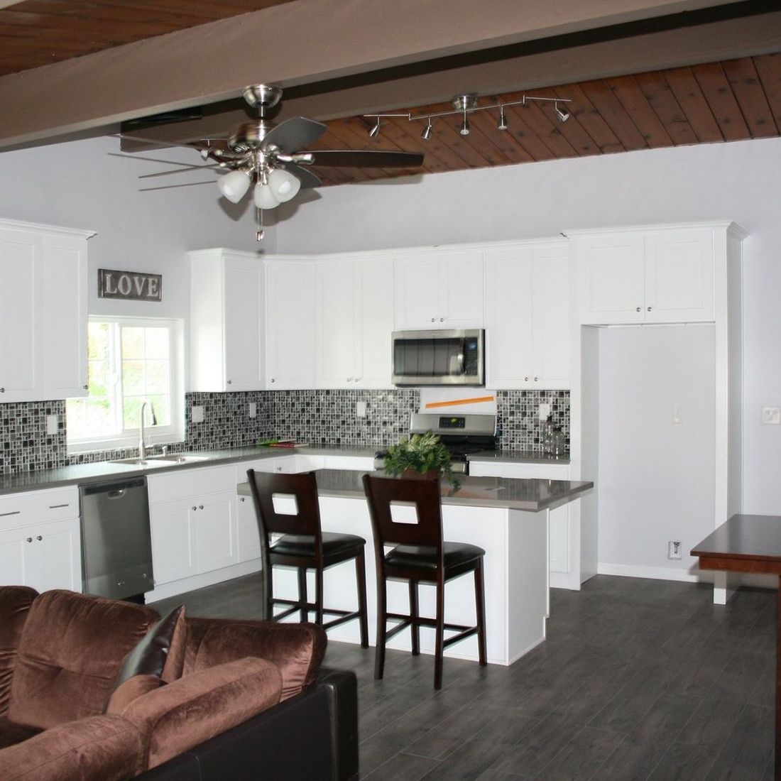 A kitchen with a sign that says love on it