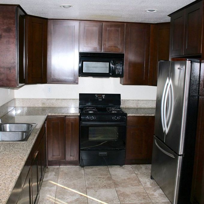 A kitchen with stainless steel appliances and wooden cabinets