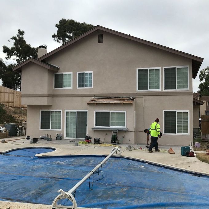 A large house with a swimming pool in front of it