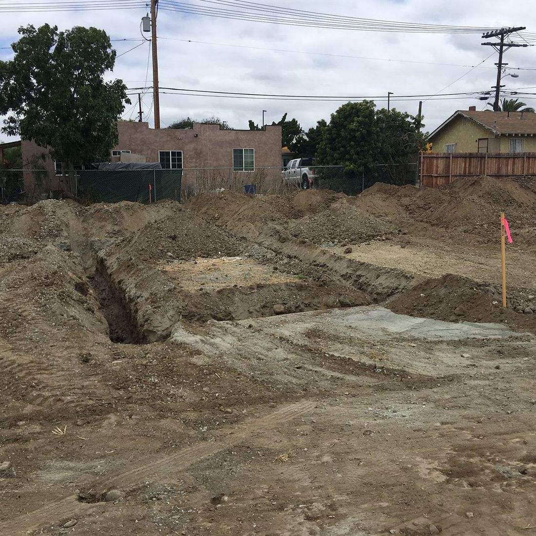 A large pile of dirt in front of a house