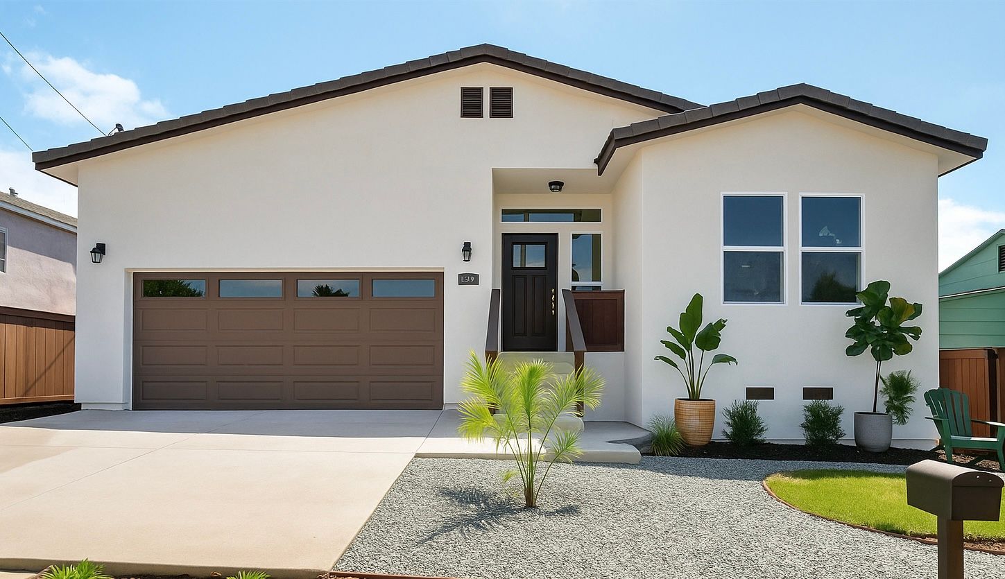 Beige stucco house with brown trim, garage door, and front door, landscaped yard, blue sky.