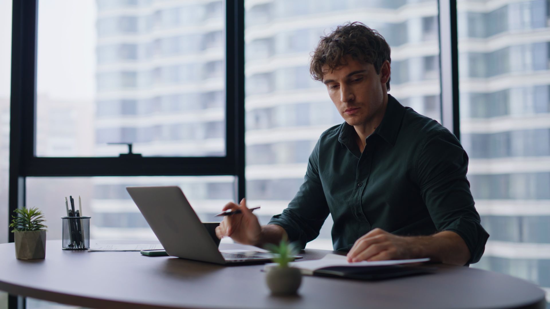 A man and a woman are looking at a laptop computer.