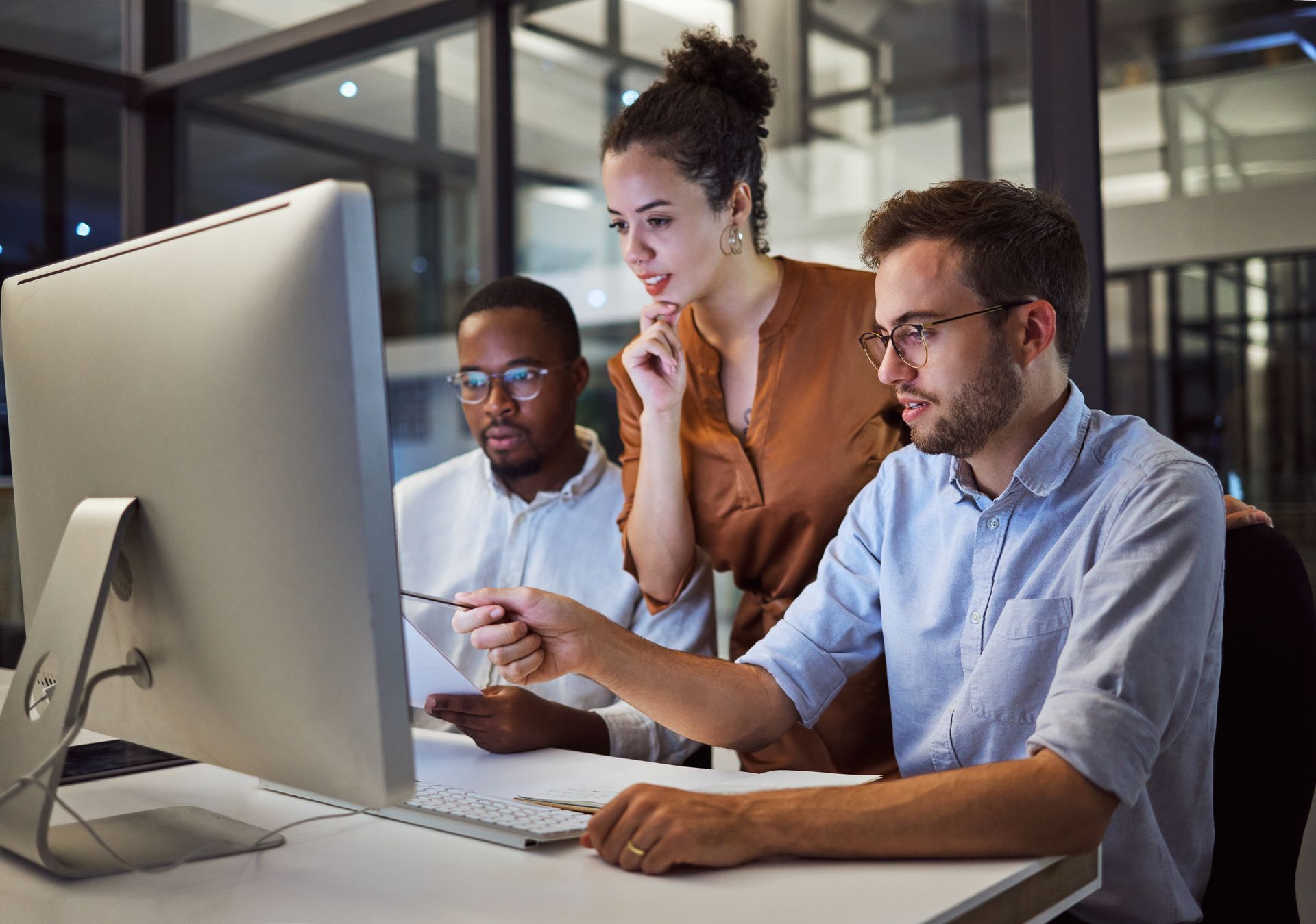 A man and a woman are looking at a laptop computer.