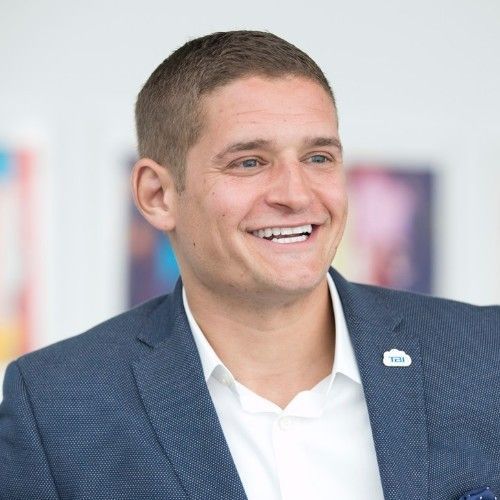 A man in a suit and tie is walking down the street