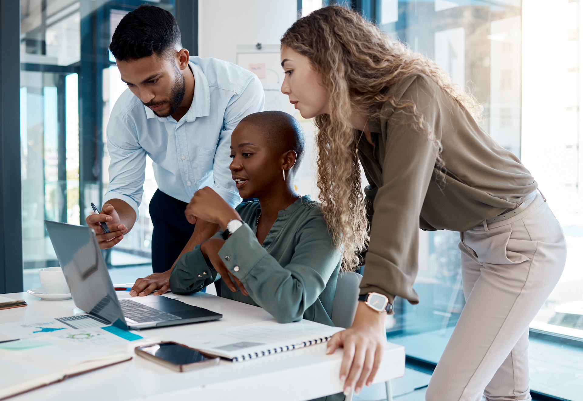 A group of people are looking at a laptop computer.