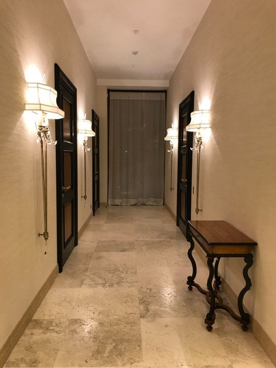 A hallway with newly installed large format ceramic tile floors