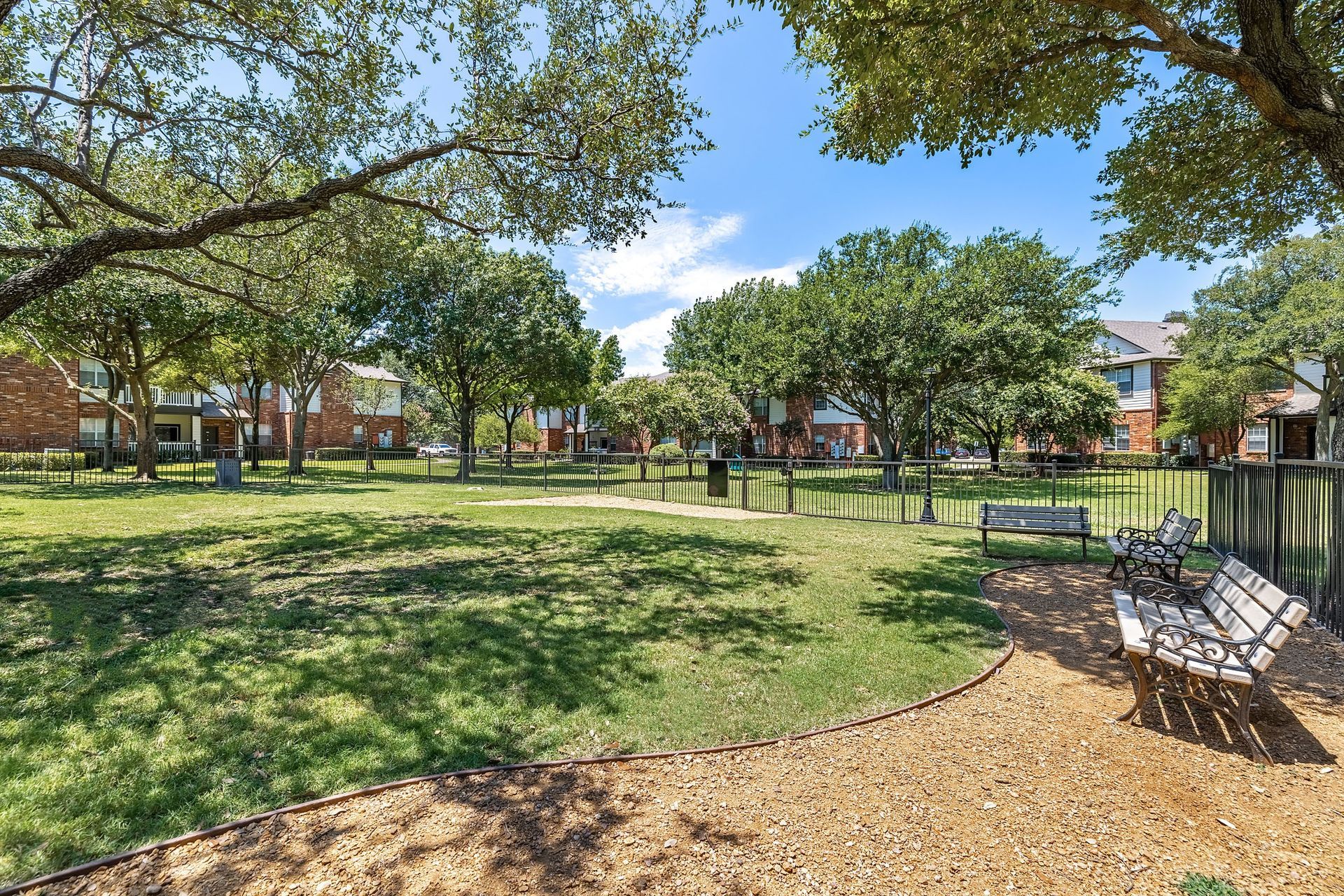 Apartment outdoor green space with benches at Marquis at Stonebriar in Frisco, TX.