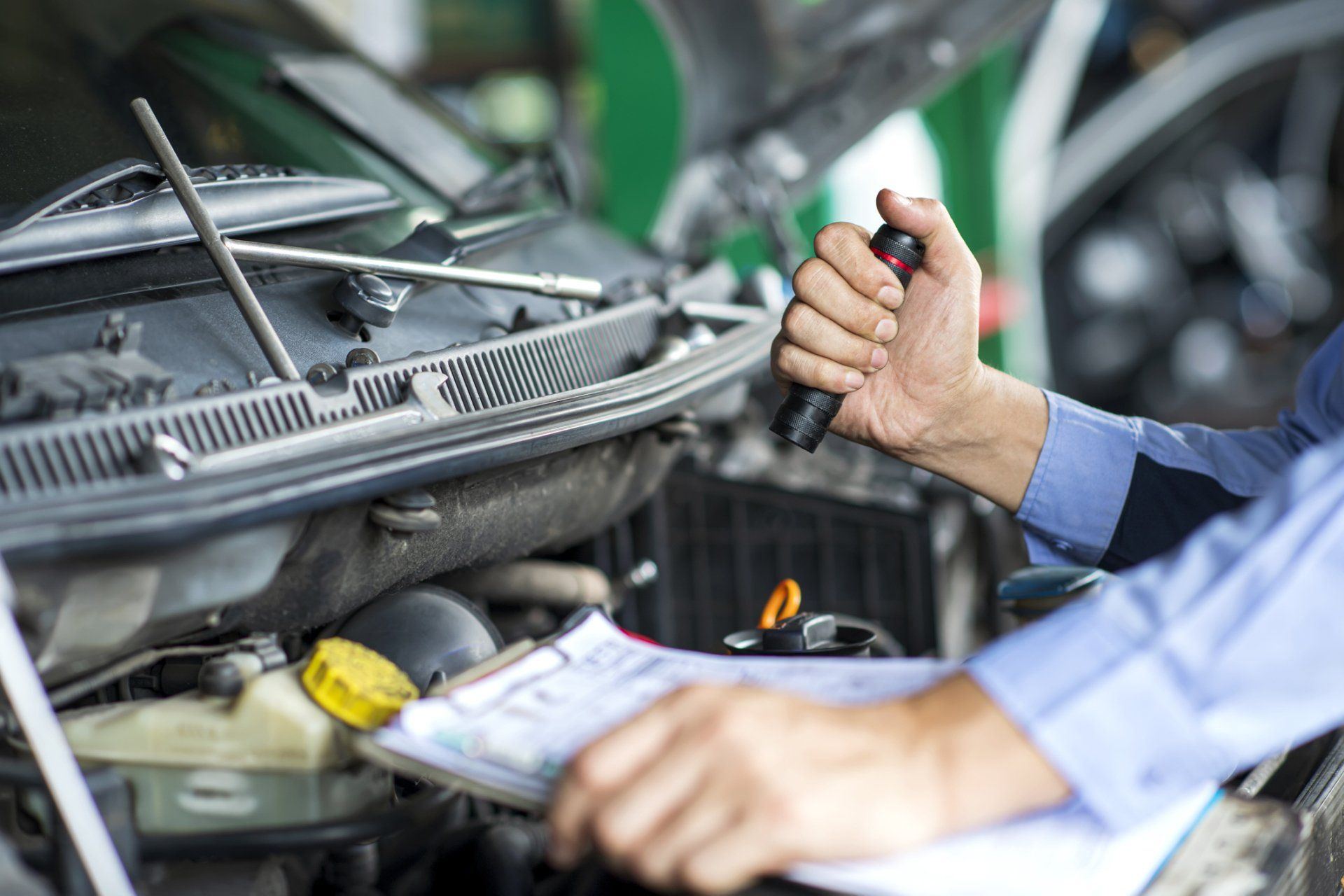 Man Inspecting A Car— Honeoye Falls, New York — Townline Garage