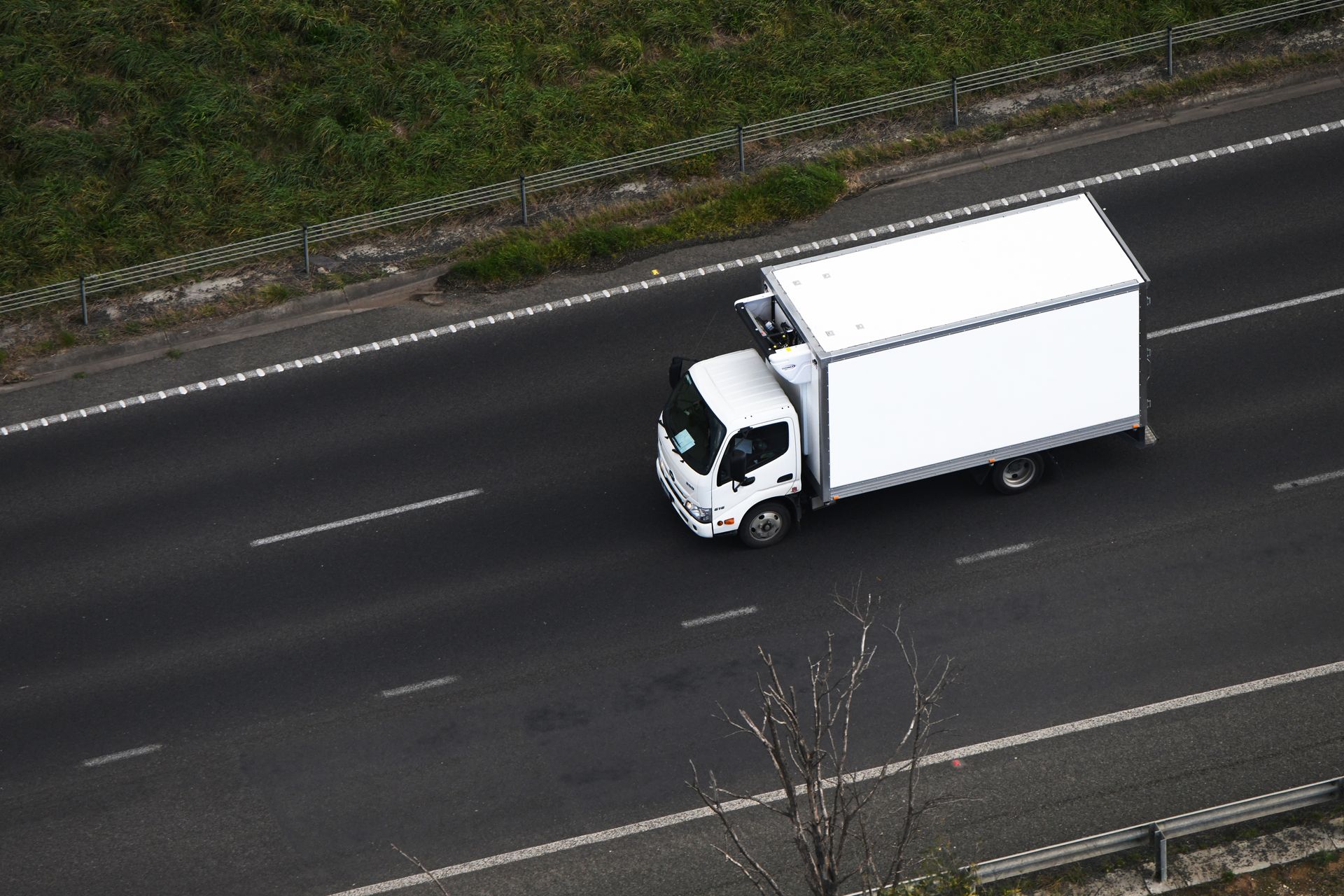 A white semi truck is driving down a highway