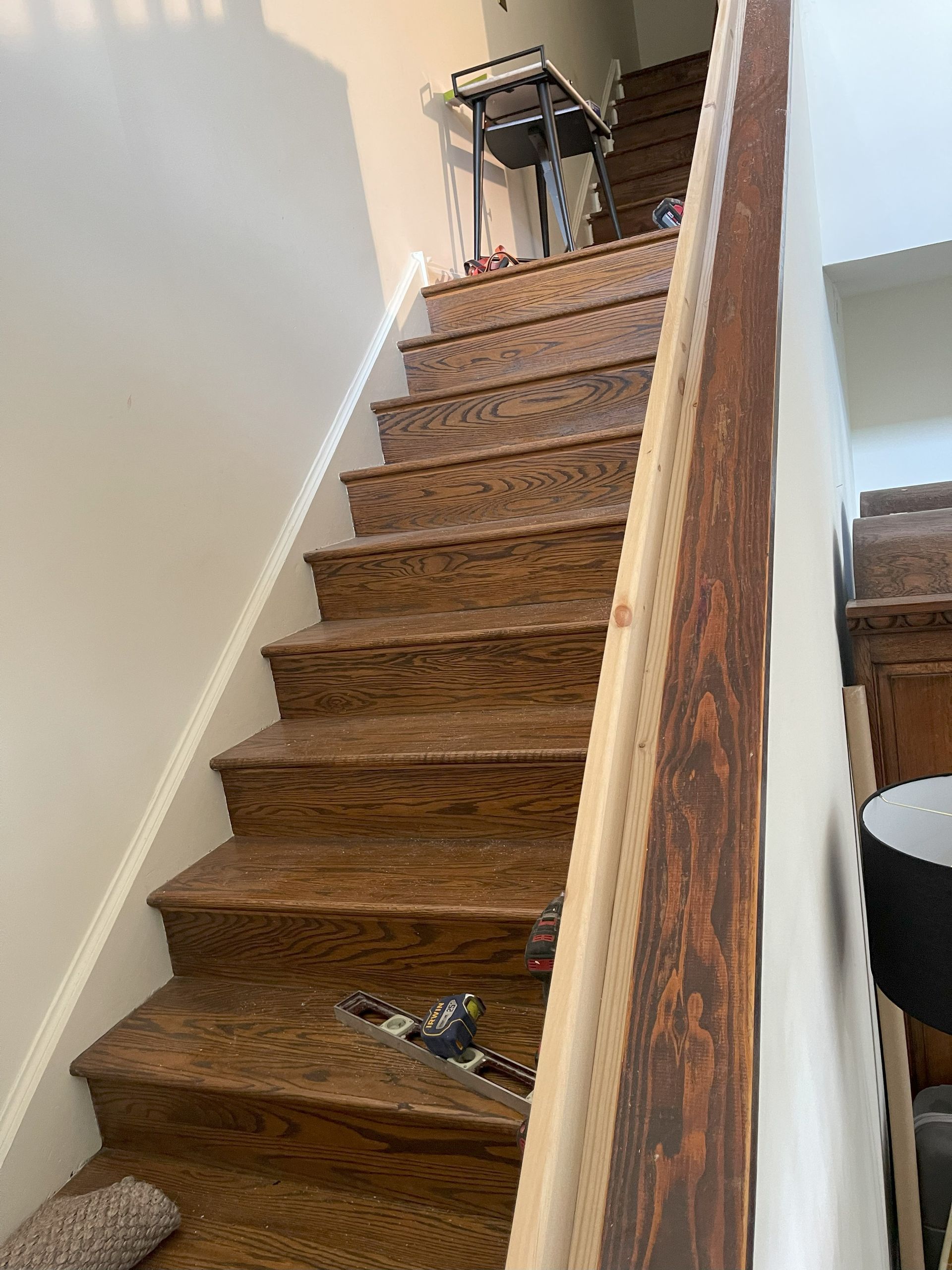 A set of wooden stairs leading up to the second floor of a house.